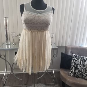 Ivory colored sleeveless mesh and lace dress